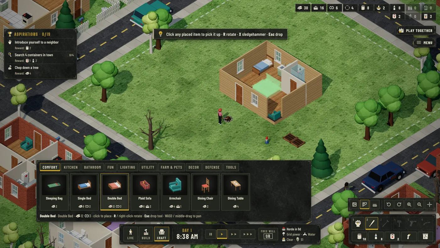 Same isometric homestead by day, with the Craft mode catalogue panel open across the bottom of the screen. Tabs read Comfort, Kitchen, Bathroom, Fun, Lighting, Utility, Farm & Pets, Decor, Defense, Tools; cards show Sleeping Bag, Single Bed, Double Bed, Plaid Sofa, Armchair, Dining Chair and Dining Table with material costs, and Double Bed is highlighted. A translucent green placement footprint sits on the wooden floor inside the house. A hint line reads: Double Bed, click to place, R / right-click rotate, Esc drop tool. A banner at the top reads: Click any placed item to pick it up.